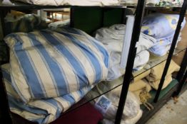 A quantity of blue stripe and blue floral curtains.