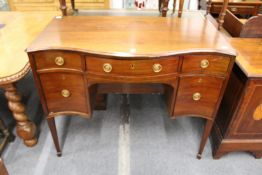 A Georgian style mahogany serpentine fronted sideboard.