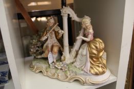 A continental porcelain group of a male violin player and a female harpist.