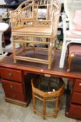 A bamboo armchair and similar glass top table.
