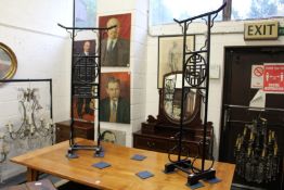 a pair of unusual Chinese style black lacquer clothes stands.