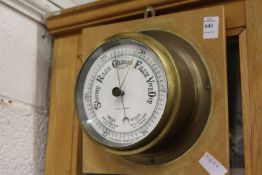 A ship's style brass cased barometer.