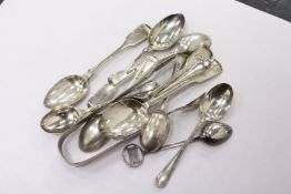 A pair of silver sugar tongs, various spoons.