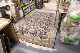 A good Persian rug, blue ground with stylized floral decoration.
