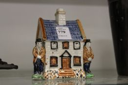 A pearlware Staffordshire cottage.