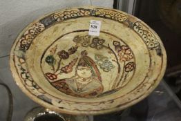 Decorative painted and incised Islamic pottery bowl.