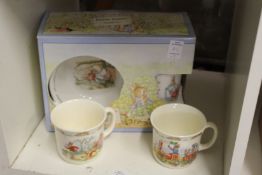 A Peter Rabbit boxed breakfast set and two other cups.