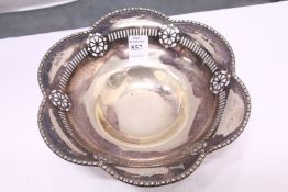 A silver pedestal bowl with pierced decoration, engraved with various signatures.