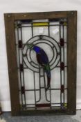 A stained glass panel depicting a parrot.