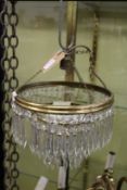 A brass and cut glass hanging chandelier.