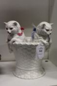 An unusual white porcelain vase modelled as two kittens climbing out of a basket.