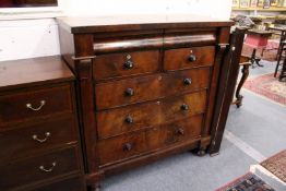 A 19th century mahogany chest of drawers with a cushion moulded drawer above two short and three