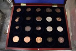 A quantity of coins and tokens housed in a purpose made travelling case.