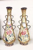 A pair of Austrian twin handled pottery vases painted with flowers.