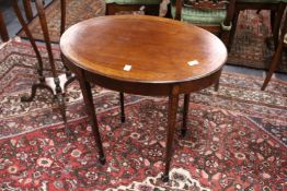 A pretty mahogany oval table with inlaid decoration.