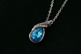 A decorative modern pendant and silver chain.