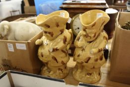 A pair of Staffordshire Toby jugs with treacle glazed decoration (AF).
