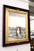 A decorative gilt framed mirror contained in a velvet lined case.
