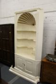 A 19th century cream painted barrel back corner niche with cupboards below.