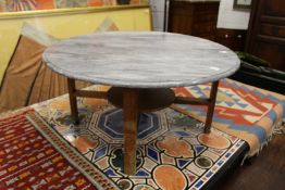 A circular marble topped coffee table.