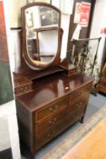 An Edwardian inlaid mahogany dressing chest.