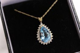 A 9ct gold diamond and blue stone pear shaped pendant and chain.