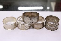 Five silver serviette rings.