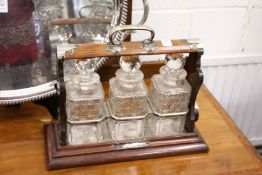 A good oak and plated three bottle tantalus.