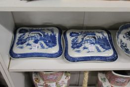 A pair of blue and white vegetable dishes and covers.