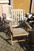 A pair of folding hardwood garden armchairs.