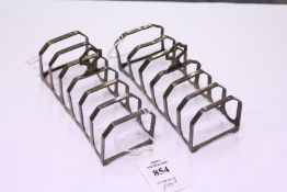 A small pair of silver six division toast racks.