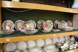 A 19th century ironstone part service decorated in the Imari palate to include plates, lead shaped