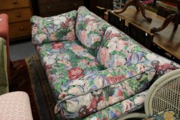 A floral upholstered settee.