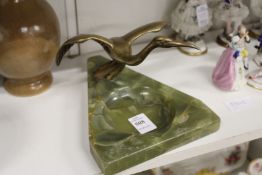 An alabaster desk stand mounted with a bronze bird.