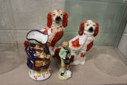Two Staffordshire dogs, a Toby jug and a figure of a young boy.