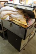 A metal trunk containing eiderdowns together with a two drawer metal filing cabinet.