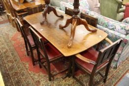 An oak refectory style dining table together with a set of six chairs, two with arms.