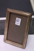 A plain silver photograph frame, 6ins x 4ins, Birmingham 1940.