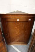 A 19th century oak hanging corner cupboard.