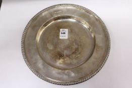 A circular silver plate with gadrooned edge, 9ins diameter, Sheffield 1928, 15ozs.