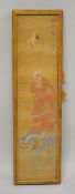 A JAPANESE PAINTED TEXTILE PICTURE OF A ARHAT HOLDING HIS BOWL - stood upon the shi shi dog, the