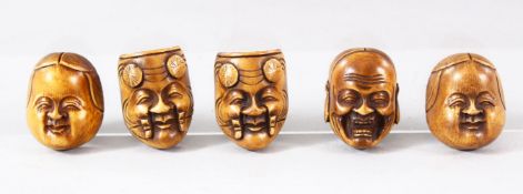FIVE SMALL JAPANESE CARVED HANNYA / DARUMA MASKS, each approx. 3.5cm x 2.5cm.
