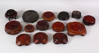 A MIXED LOT OF 19TH / 20TH CENTURY CHINESE CARVED STANDS - of varying size style and timber - (14)