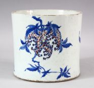 A CHINESE BLUE, WHITE & IRON RED PORCELAIN BRUSH POT - decorated with tree blooms, the base with a
