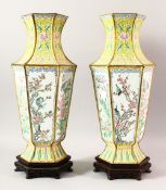 A LARGE PAIR OF CHINESE ENAMEL VASES & STANDS, the vases decorated upon a yellow ground with