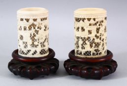A PAIR OF 19TH CENTURY CHINESE CANTON CARVED IVORY OPENWORK VASES & STANDS - decorated with scenes