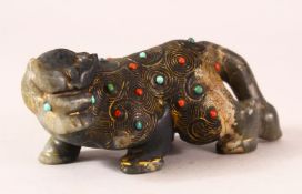 AN INDIAN CARVED AND GILDED INLAID JADE FIGURE of a buffalo, in a prowling pose, inset with