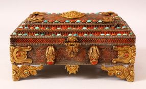 A TIBETAN MOUNTED AND INLAID METAL CASKET, the body with openwork style inlay, with gilt raised