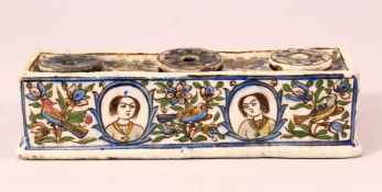 A GOOD PERISAN QAJAR POTTERY INKWELL - with floral decoration and removable wells - 20cm wide
