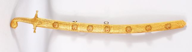 AN ORNAMENTAL ISLAMIC SWORD / SAIF AND GILT SCABBARD, the blade with embossed calligraphy, the